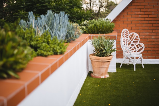 a-chair-and-potted-plants-on-a-patio-