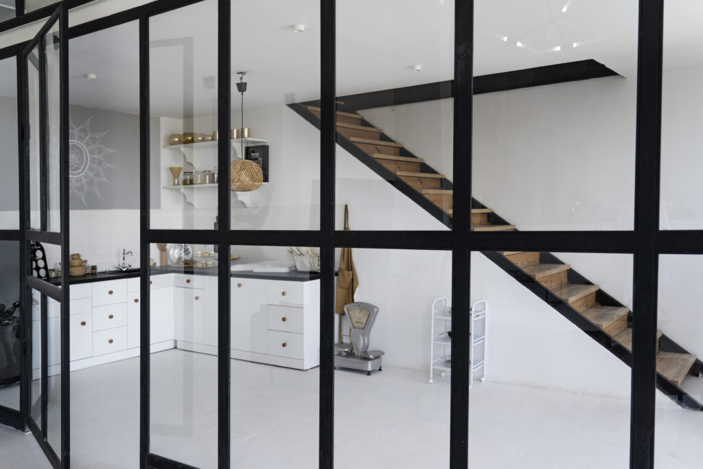 Modern interieur met zwarte stalen deuren en grote glasvlakken